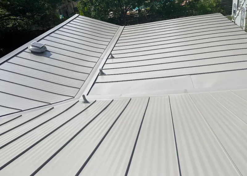 Solar attic fan installed on a metal roof for Roof Ventilation in Pleasant Garden